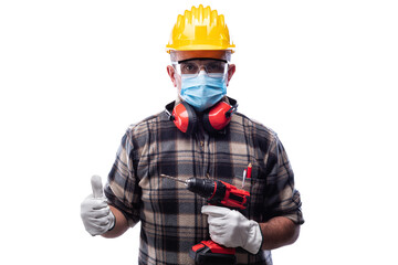 Carpenter worker isolated on white background wears surgical mask to prevent Coronavirus spread, makes OK sign with thumb up. Preventing Pandemic Covid-19 at the workplace.