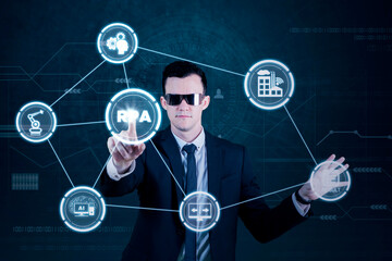 Male executive touching virtual RPA button
