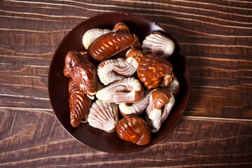 a lot of variety chocolate pralines in a plate. Top view.