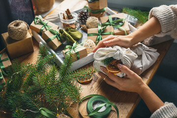 Christmas zero waste eco Care package,furoshiki gifts environmentally friendly gift wrapping craft paper fir branches, cozy winter winter evening Christmas Eve,ecological concept eco-friendly xmas