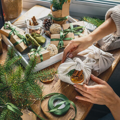 Christmas zero waste eco Care package,furoshiki gifts environmentally friendly gift wrapping craft paper fir branches, cozy winter winter evening Christmas Eve,ecological concept eco-friendly xmas