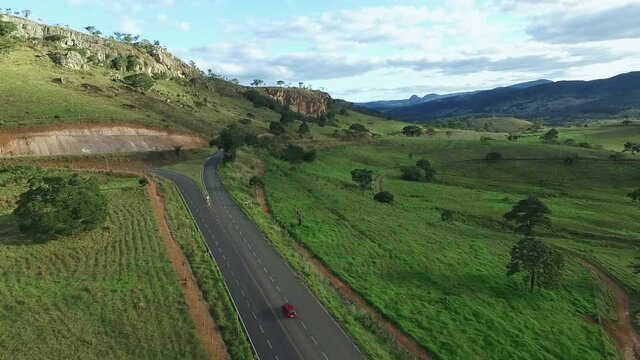 Aerial, pov, a red car on a scenic route, Brazil
