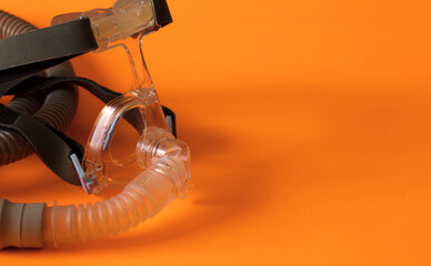 assisted respirator mask on orange background