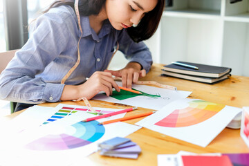 Asian woman fashion designer work at home happily. Internship designer about fashion clothing.