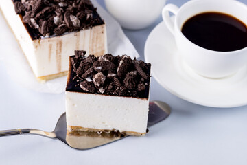 Piece of Tasty Homemade Vanilla Souffle or Mousse Cake Decorated with Chocolate and Cookies Cup of Black Coffee Blue Background Tasty Holiday Dessert