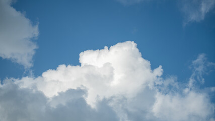 Naklejka na ściany i meble Big white cloud in a blue sky 