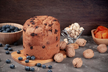 panettone on a marble table, blueberry and nut spread, selective focus and copy space