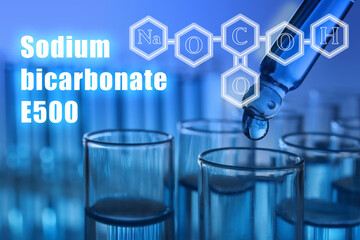 Text Sodium bicarbonate E500 with soda formula and test tubes on background