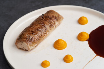 Baked chicken roulade with pumpkin sauce. Chicken roll