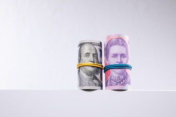 rolls of dollars and hryvnias isolated on white background, close view