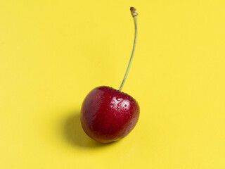 bright juicy ripe cherry berry isolated on a yellow background