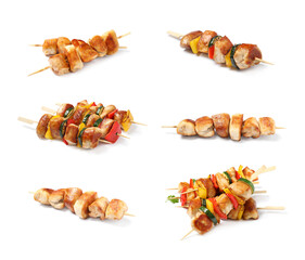 Set of delicious chicken shish kebabs on white background