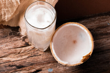 Coconut water in a glass and young coconut