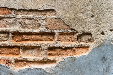 Closeup damaged old brick wall texture background, crack cement wall background, outdoor day light, construction concept