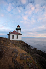 Fototapeta na wymiar Lime Kiln lighthouse along the rocky shoreline of San Juan Island, Washington State
