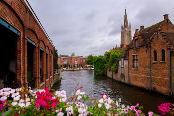 Bruges, Flanders, Belgium, Europe - October 1, 2019. Medieval ancient houses made of old bricks and water canals on ancient medieval street in Bruges (Brugge)