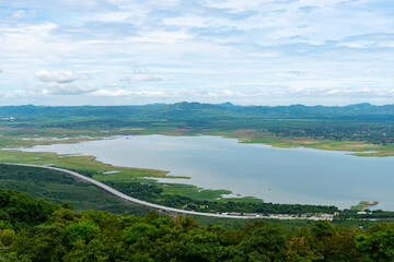 top view of the lake and highway road passing through green field