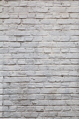 old wall made of rectangular white bricks sealed with cement
