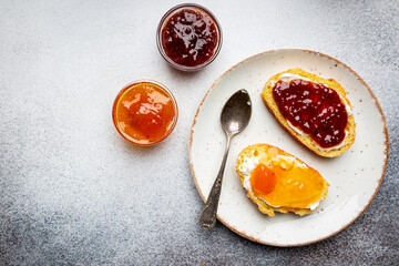 Sandwich with various sweet fruit jams and cottage cheese on light background, top view with copy space