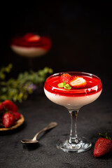 Italian panna cotta dessert with strawberry sirup and mint leaf