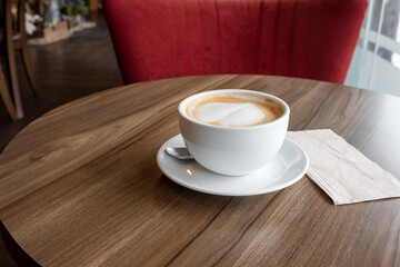 closed-up of hot drink coffee in white mug on brown wood table