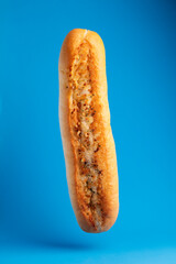 floating garlic bread on blue backround