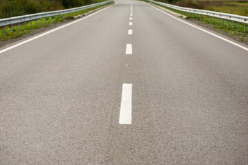 Smooth asphalt road with bumpers and markings