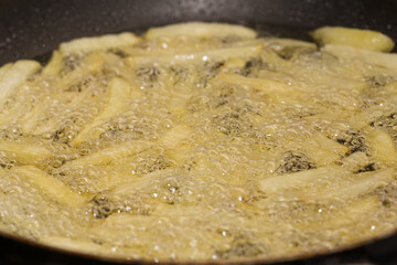 French fries frying in hot oil