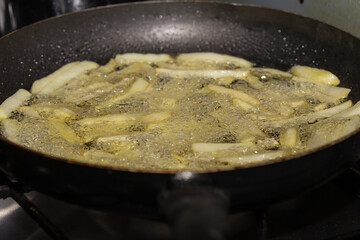 French fries frying in hot oil