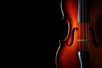 Violin on a black background. Ancient stringed instrument. Classical music.