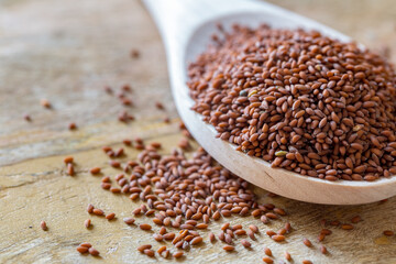 garden cress seeds in the wooden spoon (Lepidium sativum), curly cress on a wooden table