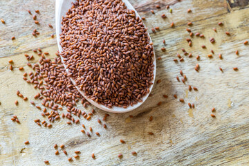 garden cress seeds in the wooden spoon (Lepidium sativum), curly cress on a wooden table