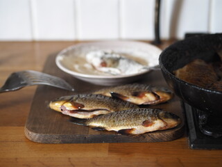 The process of frying river fish crucian carp, previously boned in flour, in a frying pan on a stove.River fish of the rivers of Russia.