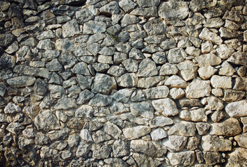 wall of beige natural stones, rubble masonry