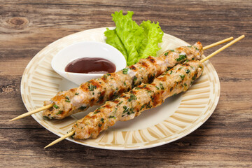 Minced pork skewer kebab with sauce
