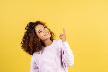 Young afro american woman on yellow copy space background