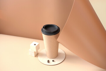  coffee mug and coffee beans on a beige background. coffee to go or take away drink in reusable mug. sustainable and eco product. minimal style. trendy set up. copy space for text.