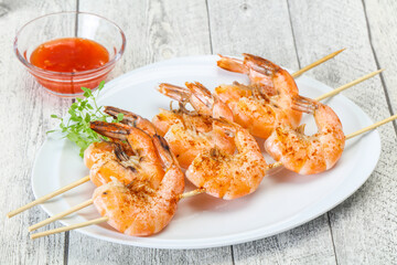 Grilled prawn skewer with sauce