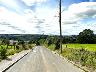 Park Lane, with fields, trees, and houses in the distance in, Halifax, Yorkshire, UK