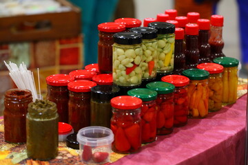 Canned tomatoes and cucumbers in glass jars