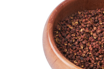 sichuan pepper in wooden bowl isolated on white background with clipping path