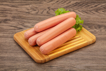 Tasty meat sausages over board