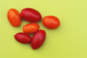 Ripe tomatoes on a yellow background. Flat lay