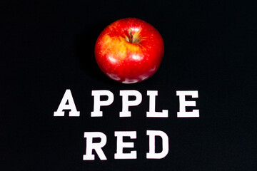 The red Apple is located in the center of the frame.
