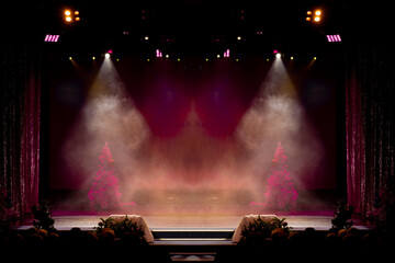 Theater before the performance of artists. Bright colored light and scene with Christmas trees.