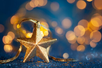 Festive  Golden Christmas Star with blurred gold lights background. Christmas or New Year concept...