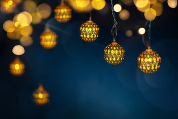 Festive Decoration with Garland Lights on dark blue background with bright bokeh. Christmas or New Year background