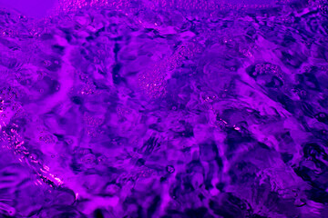 splash of water in lilac light. Abstract wallpaper