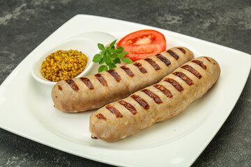 Grilled natural pork sausages with sauce