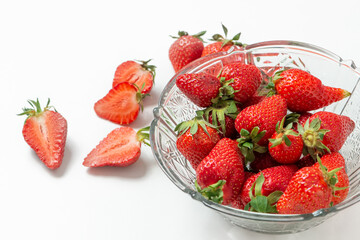 Fresh strawberry in ceramic jar on white